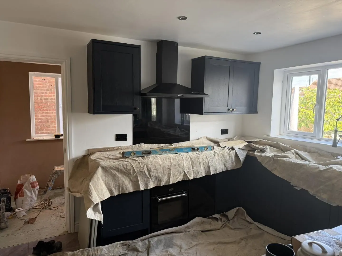 Navy kitchen before brick slip installation, worktops protected