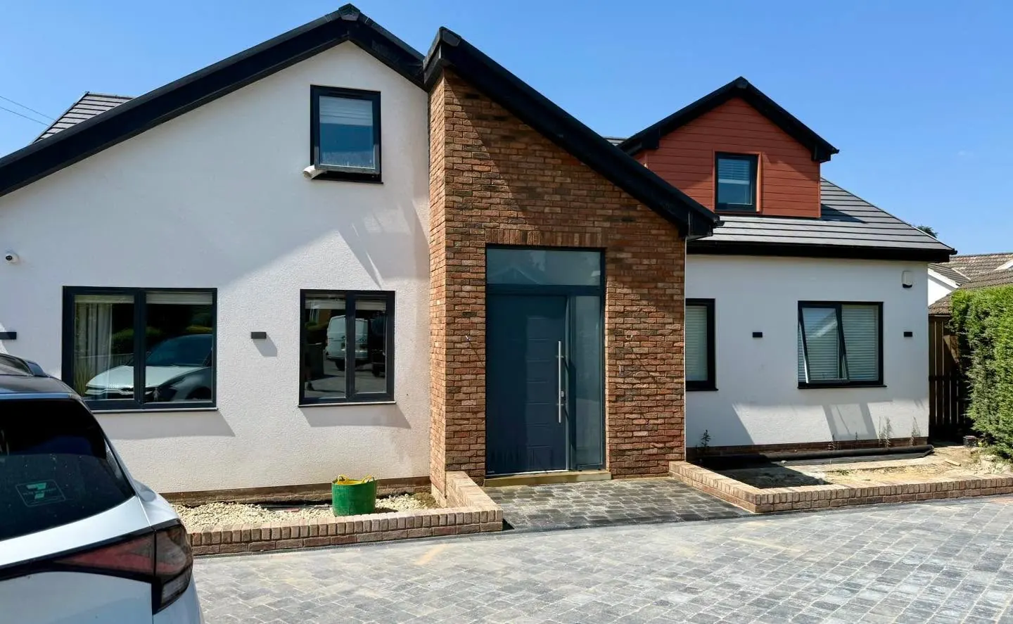 House entrance porch clad in warm brick slips after completion