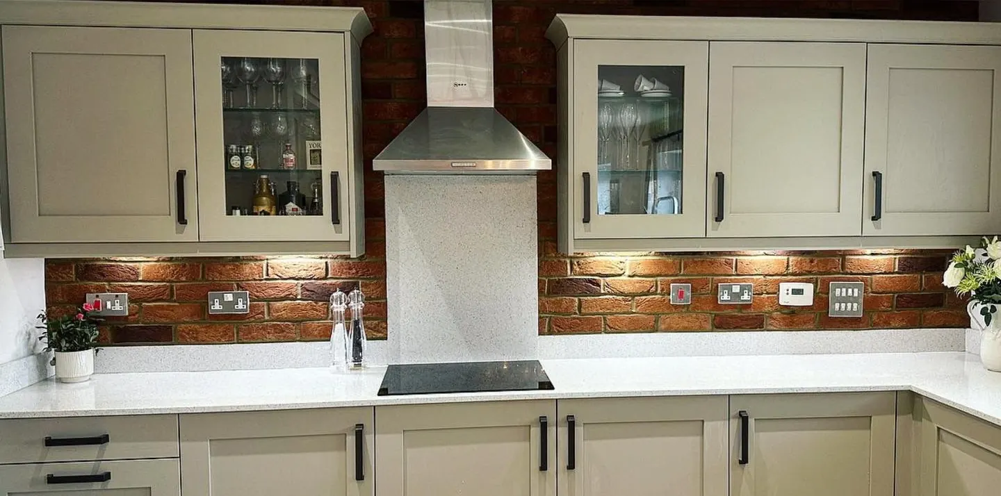 Red brick slip kitchen splashback fitted in a cream kitchen